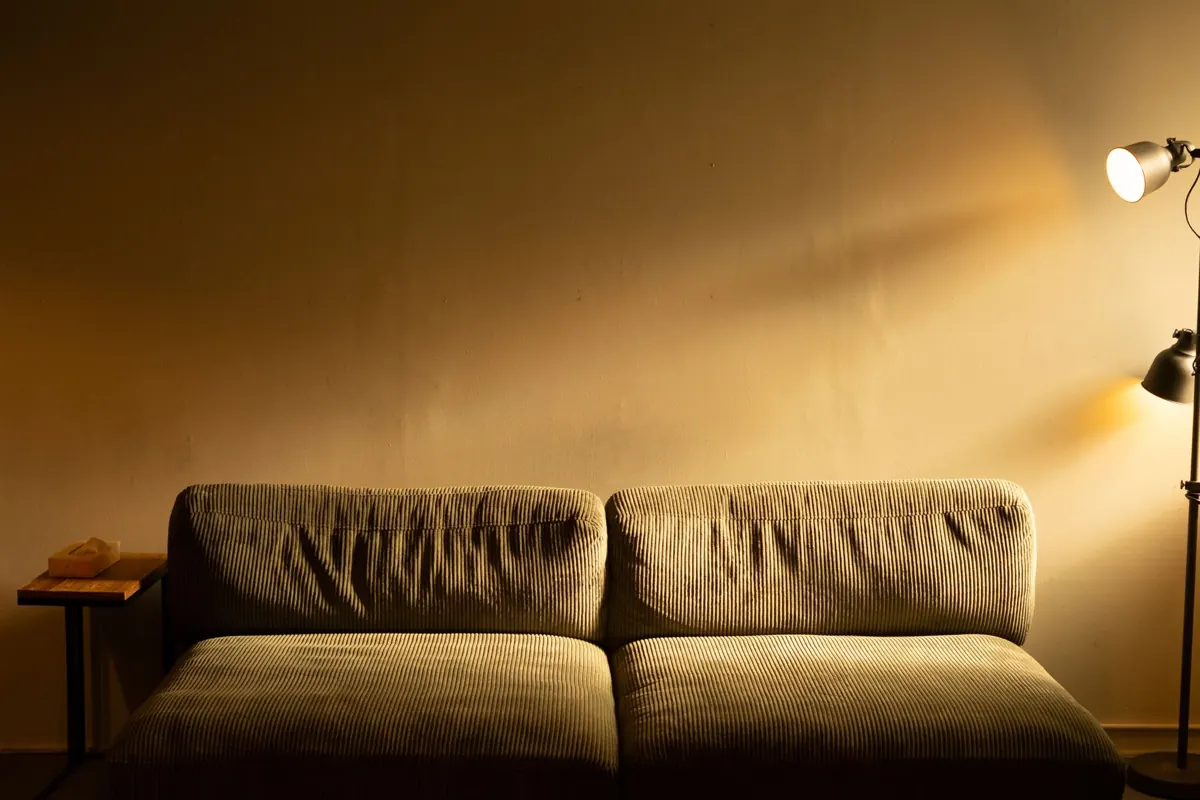 Soffa i varmt kvällsljus från en golvlampa