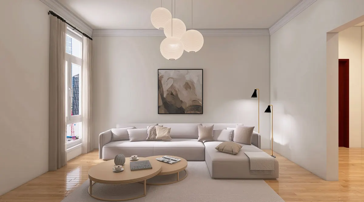 Ljust vardagsrum med soffa, runda soffbord och golvlampa